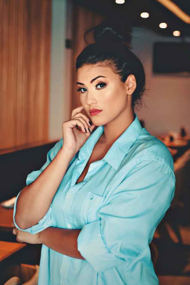 woman wearing teal collared top